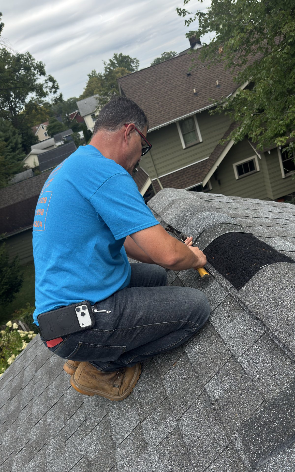 Sammy hand-nailing ridge cap shingles during a roof repair in Bernardsville NJ