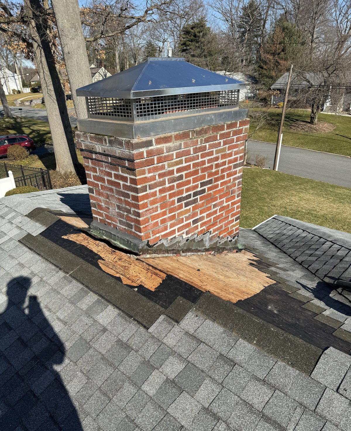 Chimney flashing repair with decking exposed on a roof in Hopatcong NJ near Lake Hopatcong