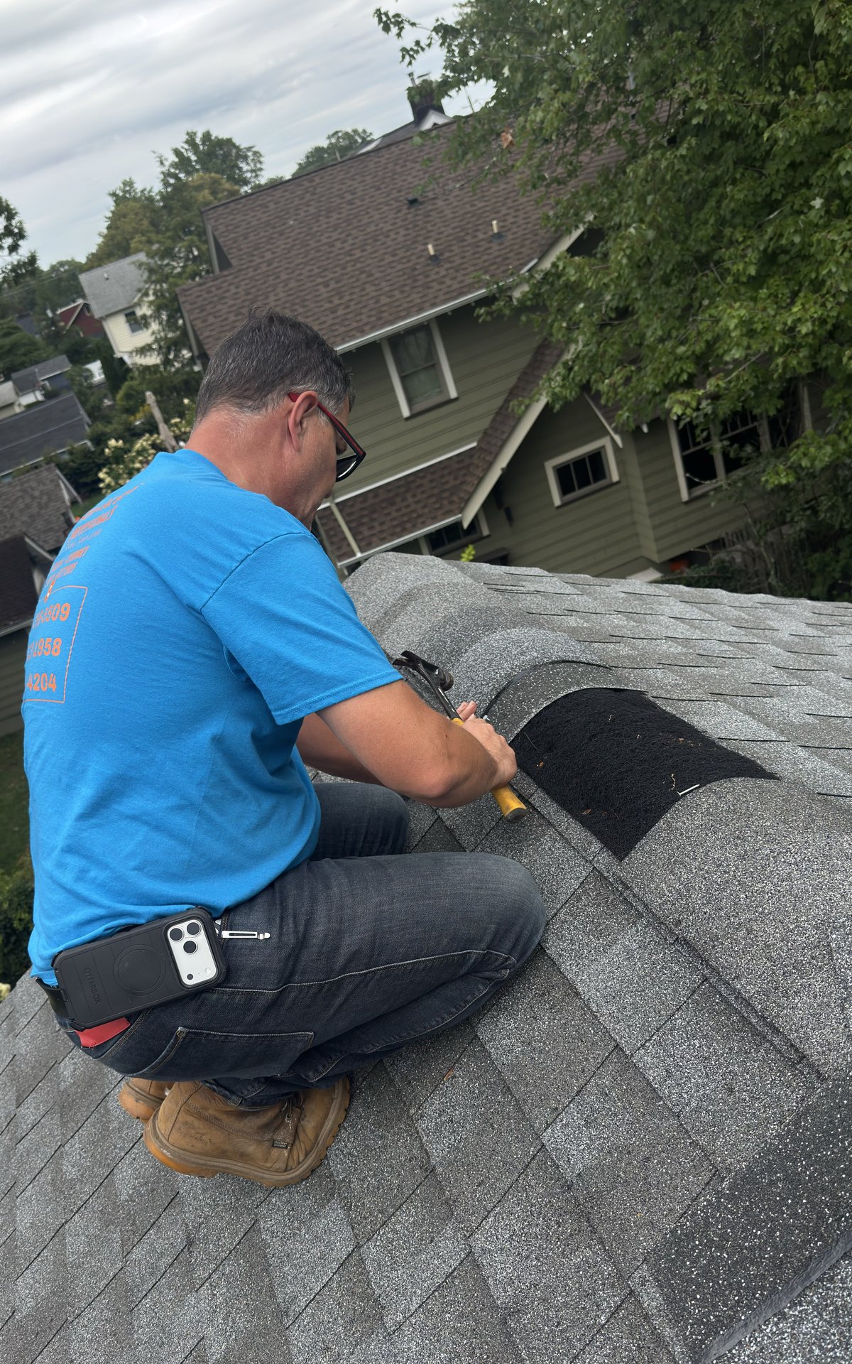 Sammy hand-nailing ridge cap shingles during a roof repair in a Succasunna NJ neighborhood